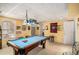 Basement game room with pool table, sports-themed décor, and bar-style seating at 230 Cobblestone Ln, Mcdonough, GA 30252