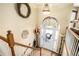 Foyer and staircase with views to a stained glass transom over front door at 230 Cobblestone Ln, Mcdonough, GA 30252