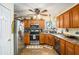 Kitchen featuring wooden cabinets, tile floor and stainless steel appliances at 230 Cobblestone Ln, Mcdonough, GA 30252