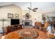 Living room featuring a brick fireplace and vaulted ceilings at 230 Cobblestone Ln, Mcdonough, GA 30252