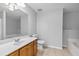 Bright bathroom features a large mirror, single sink vanity, and a separate soaking tub at 3044 Lauren Parc Rd, Decatur, GA 30032