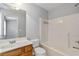Bathroom featuring a single sink vanity with framed mirror and a shower-tub combo at 3044 Lauren Parc Rd, Decatur, GA 30032