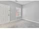 Cozy bedroom featuring neutral carpet, a window, and a white door at 3044 Lauren Parc Rd, Decatur, GA 30032