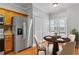 Cozy dining area complemented by stainless steel refrigerator and functional pantry closet at 3044 Lauren Parc Rd, Decatur, GA 30032