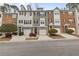 Townhome exteriors with individual garages and varied brick, siding, and stone accents at 3044 Lauren Parc Rd, Decatur, GA 30032