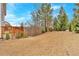 Sloped backyard with ample space and trees at 108 Rex Ave, Canton, GA 30114