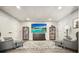 Finished basement with gray flooring, two armchairs, and large TV at 159 Geneva Rd, Canton, GA 30114