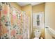 Small bathroom with shower/tub combo, floral shower curtain, and window at 159 Geneva Rd, Canton, GA 30114