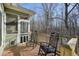 Deck with rocking chairs, screened porch, and wooded view at 159 Geneva Rd, Canton, GA 30114