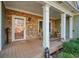 Covered front porch with stone facade, rocking chairs, and wood flooring at 159 Geneva Rd, Canton, GA 30114