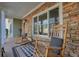 Covered porch with stone exterior and rocking chairs at 159 Geneva Rd, Canton, GA 30114