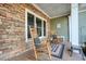 Relaxing covered porch with stone wall and rocking chairs at 159 Geneva Rd, Canton, GA 30114
