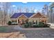 Charming one-story home with manicured landscaping, brick accents, and a welcoming front porch at 159 Geneva Rd, Canton, GA 30114