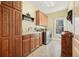 Laundry room with wooden cabinets, washer, dryer, and sink at 159 Geneva Rd, Canton, GA 30114
