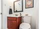 Small bathroom with wood vanity and white tile at 6940 Roswell Rd # 16B, Atlanta, GA 30328