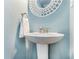 Small bathroom with pedestal sink and decorative mirror at 6940 Roswell Rd # 16B, Atlanta, GA 30328