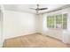 Bright bedroom with ceiling fan and neutral carpeting at 6940 Roswell Rd # 16B, Atlanta, GA 30328