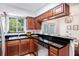 Galley kitchen with stainless steel appliances and dark countertops at 6940 Roswell Rd # 16B, Atlanta, GA 30328
