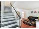 Modern staircase with black and white painted risers and wood handrail at 6940 Roswell Rd # 16B, Atlanta, GA 30328