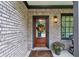 Inviting front entrance with a wooden door, brick facade, and potted plants at 1849 8Th St, Atlanta, GA 30341