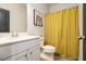 Clean bathroom with white vanity and yellow shower curtain at 200 Wallace St, Fayetteville, GA 30214
