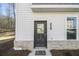 Close-up of the front door with brick accents, a private residence sign, and the house number at 200 Wallace St, Fayetteville, GA 30214