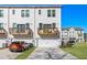 Rear exterior view of townhomes with balconies, garages, and landscaped surroundings at 200 Wallace St, Fayetteville, GA 30214