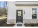 Dark gray front door with glass panels and brick base at 200 Wallace St, Fayetteville, GA 30214