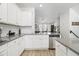 Modern kitchen with white cabinets and gray countertops at 200 Wallace St, Fayetteville, GA 30214