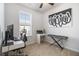 Home office with a desk, keyboard, and large art piece at 200 Wallace St, Fayetteville, GA 30214