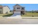 Two-story home with gray siding, brick accents, and a two-car garage at 247 Tulip Dr, Covington, GA 30016