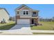 Two-story home with gray siding, brick accents, and a two-car garage at 247 Tulip Dr, Covington, GA 30016