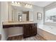 Bathroom with soaking tub, vanity, and granite countertop at 218 Cynthia Ct, Dallas, GA 30157