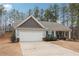 Ranch style home with gray siding, white garage door, and landscaping at 218 Cynthia Ct, Dallas, GA 30157