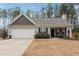 Charming one-story house with gray siding, a white garage door, and a landscaped yard at 218 Cynthia Ct, Dallas, GA 30157