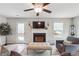 Spacious living room featuring a fireplace, hardwood floors, and a ceiling fan at 218 Cynthia Ct, Dallas, GA 30157