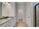 Bathroom with double vanity, large mirror, and walk-in shower at 258 Tulip Dr, Covington, GA 30016