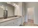 Main bathroom with double vanity and access to walk-in closet at 258 Tulip Dr, Covington, GA 30016