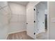 Walk-in closet with wire shelving and access to bathroom at 258 Tulip Dr, Covington, GA 30016