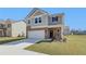 Two-story house with gray siding, brick accents, and a two-car garage at 258 Tulip Dr, Covington, GA 30016