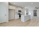 Open concept kitchen with island, stainless steel appliances, and view to living room at 258 Tulip Dr, Covington, GA 30016