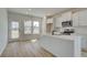 Modern kitchen features white cabinets, stainless steel appliances, and a large island at 258 Tulip Dr, Covington, GA 30016