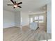 Open living room and kitchen with hardwood floors and ceiling fan at 258 Tulip Dr, Covington, GA 30016
