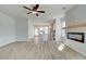 Spacious living room with hardwood floors, fireplace, and kitchen views at 258 Tulip Dr, Covington, GA 30016