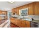 Kitchen with wood cabinets, granite countertops, and terracotta tile floors at 2773 Townley Cir, Atlanta, GA 30340