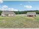 Aerial view of a house and detached garage on a large lot at 615 Henderson Mill Rd, Covington, GA 30014