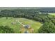 Aerial view showing home, guest house, and surrounding landscape at 615 Henderson Mill Rd, Covington, GA 30014