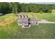 Aerial view of two story house with large backyard and detached garage at 615 Henderson Mill Rd, Covington, GA 30014