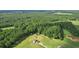 Aerial view highlighting home's secluded setting in wooded area at 615 Henderson Mill Rd, Covington, GA 30014