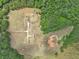Aerial view of property showing home, detached garage, and expansive green space at 615 Henderson Mill Rd, Covington, GA 30014